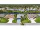 A lovely aerial view of a beautiful single Gathering home with well-manicured lawn and waterway in backyard at 223 Ne Golf Club Dr, New Smyrna Beach, FL 32168