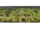 Scenic aerial shot of a golf course featuring winding paths, sand traps, mature trees, and tranquil water features at 223 Ne Golf Club Dr, New Smyrna Beach, FL 32168