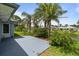 Private backyard with a patio, lush landscaping, and plenty of room for outdoor activities and enjoyment at 223 Ne Golf Club Dr, New Smyrna Beach, FL 32168