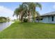 Expansive backyard with well-maintained lawn and a serene waterfront view, perfect for relaxation and recreation at 223 Ne Golf Club Dr, New Smyrna Beach, FL 32168