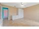 Comfortable bedroom featuring tile floors, ample closet space, and a ceiling fan for optimal comfort at 223 Ne Golf Club Dr, New Smyrna Beach, FL 32168