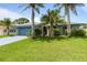 Charming single-story home with mature trees, a well-manicured lawn, and a welcoming curb appeal at 223 Ne Golf Club Dr, New Smyrna Beach, FL 32168