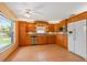 Bright kitchen featuring wooden cabinets, stainless steel appliances, and tile flooring at 223 Ne Golf Club Dr, New Smyrna Beach, FL 32168