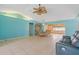 An open concept living and dining area with tiled flooring and contemporary lighting at 223 Ne Golf Club Dr, New Smyrna Beach, FL 32168