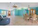 Expansive living space, dining area, and neutral tiled flooring creates a bright atmosphere at 223 Ne Golf Club Dr, New Smyrna Beach, FL 32168