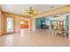 Spacious living area with tile floors, adjacent to the kitchen and dining room at 223 Ne Golf Club Dr, New Smyrna Beach, FL 32168
