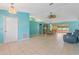 Large spacious living and dining area has ceiling fan and light fixtures at 223 Ne Golf Club Dr, New Smyrna Beach, FL 32168