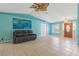 Large and bright living room with front door view and neutral tiled flooring at 223 Ne Golf Club Dr, New Smyrna Beach, FL 32168
