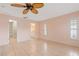 Serene main bedroom with tile flooring and access to the bathroom and walk-in closet at 223 Ne Golf Club Dr, New Smyrna Beach, FL 32168