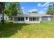 The home has a spacious backyard with a screened-in porch at 2325 Lime Tree Dr, Edgewater, FL 32141