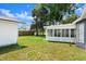 Home exterior, featuring a spacious backyard with a screened-in porch at 2325 Lime Tree Dr, Edgewater, FL 32141