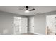 This bedroom features a ceiling fan, wood-look floors, and access to the kitchen at 2325 Lime Tree Dr, Edgewater, FL 32141