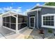 Screened-in porch and front entryway of a gray single-story home at 2325 Lime Tree Dr, Edgewater, FL 32141