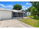 Charming gray single-story home with a two-car garage and screened-in porch at 2325 Lime Tree Dr, Edgewater, FL 32141