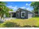 Gray single-story home with a front lawn and screened-in porch at 2325 Lime Tree Dr, Edgewater, FL 32141