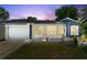 Charming single-story home with a well-manicured lawn and a screened lanai, perfect for enjoying the outdoors at 2325 Lime Tree Dr, Edgewater, FL 32141