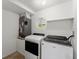 Updated laundry room with modern washer and dryer units and a small window at 2325 Lime Tree Dr, Edgewater, FL 32141