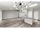 Open-concept living space featuring updated floors, stylish lighting fixtures, and seamlessly connects to the kitchen area at 2325 Lime Tree Dr, Edgewater, FL 32141