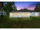 Rear exterior of home featuring lawn and bright sunroom at 2325 Lime Tree Dr, Edgewater, FL 32141