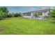 Green backyard featuring a well-maintained lawn, patio, and partial view of the home's exterior at 25 Dolphin Ave, Ormond Beach, FL 32176