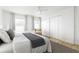 Spacious bedroom with a modern ceiling fan, window, closet, and a comfortable queen-sized bed at 25 Dolphin Ave, Ormond Beach, FL 32176
