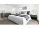 Stylish bedroom featuring modern side tables, lamps, plush rug, and a comfortable queen bed at 25 Dolphin Ave, Ormond Beach, FL 32176