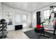 Bright home gym featuring a punching bag, workout equipment, tile floor, and access to the backyard at 25 Dolphin Ave, Ormond Beach, FL 32176