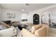 Cozy living room featuring comfortable sofas, an arched doorway, light wood floors, and a contemporary ceiling fan at 25 Dolphin Ave, Ormond Beach, FL 32176