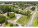Aerial view of a house surrounded by mature trees in a suburban neighborhood at 2529 Umbrella Tree Dr, Edgewater, FL 32141