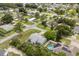 This aerial view showcases a lovely neighborhood with mature trees and glimpses of the in-ground pools at 2529 Umbrella Tree Dr, Edgewater, FL 32141