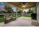 Covered back porch with ceiling fan, string lights, and outdoor seating area at 2529 Umbrella Tree Dr, Edgewater, FL 32141