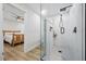 Sleek bathroom featuring a glass-enclosed shower with a modern shower-head fixture, and views of the bedroom at 2529 Umbrella Tree Dr, Edgewater, FL 32141