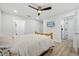Bright bedroom with a ceiling fan, tv and an ensuite bathroom, offering a modern and comfortable living space at 2529 Umbrella Tree Dr, Edgewater, FL 32141