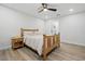 Cozy bedroom with wood furniture, natural light, wood-look flooring, and laundry room access at 2529 Umbrella Tree Dr, Edgewater, FL 32141