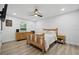 Cozy bedroom with wood furniture, natural light, and wood-look flooring at 2529 Umbrella Tree Dr, Edgewater, FL 32141
