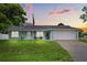 Charming single-story home with well-manicured lawn, neutral paint, and an attached two car garage at 2529 Umbrella Tree Dr, Edgewater, FL 32141