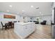 Bright kitchen featuring white cabinets, stainless steel appliances, island and view of the living room at 2529 Umbrella Tree Dr, Edgewater, FL 32141