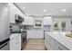 Bright kitchen featuring white cabinets, stainless steel appliances, and island at 2529 Umbrella Tree Dr, Edgewater, FL 32141