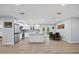 Bright kitchen with white cabinets, stainless appliances, an island with sink, and open to the dining area at 2529 Umbrella Tree Dr, Edgewater, FL 32141