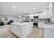 Bright kitchen featuring white cabinets, stainless steel appliances, and an island with seating at 2529 Umbrella Tree Dr, Edgewater, FL 32141