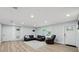 Cozy living room with wood flooring and a comfortable leather sectional sofa, plus a recliner at 2529 Umbrella Tree Dr, Edgewater, FL 32141