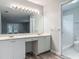 Bright bathroom featuring a double vanity, large mirror, and walk-in shower at 2628 Vista Palm Dr, Edgewater, FL 32141