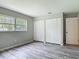 Bright bedroom with wood-look floors, and a window overlooking the yard at 2628 Vista Palm Dr, Edgewater, FL 32141