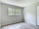 This bedroom has hard surface floors, a window, and a closet at 2628 Vista Palm Dr, Edgewater, FL 32141