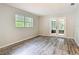 Bright bedroom with wood-look floors and French doors to screened patio at 2628 Vista Palm Dr, Edgewater, FL 32141