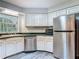 Modern kitchen with stainless steel appliances, white cabinets, and ample counter space at 2628 Vista Palm Dr, Edgewater, FL 32141