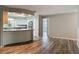 Open-concept view of updated kitchen and dining area with hardwood flooring at 2628 Vista Palm Dr, Edgewater, FL 32141