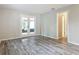 Open living area with wood-look floors and French doors to screened patio at 2628 Vista Palm Dr, Edgewater, FL 32141