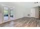 Bright living area featuring wood-look floors and French doors to screened porch at 2628 Vista Palm Dr, Edgewater, FL 32141