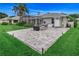Well-maintained backyard with a paved patio area, hot tub, and outdoor shower, ideal for relaxation and entertainment at 2632 Turnbull Estates Dr, New Smyrna Beach, FL 32168